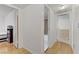 Bright hallway featuring hardwood floors, access to bathroom and bedroom with books on shelves at 4998 Schumann Dr, Las Vegas, NV 89146