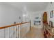 Upstairs hallway with hardwood floors and white banister at 4998 Schumann Dr, Las Vegas, NV 89146