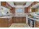 Traditional kitchen with granite countertops, tile backsplash, and wooden cabinetry at 4998 Schumann Dr, Las Vegas, NV 89146