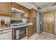 Kitchen with stainless fridge, wooden cabinetry, and oven at 4998 Schumann Dr, Las Vegas, NV 89146