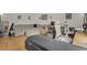 Living room with hardwood floors, white walls, and a gray L shaped couch at 4998 Schumann Dr, Las Vegas, NV 89146