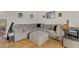 Living room with hardwood floors, white walls, and a gray L shaped couch at 4998 Schumann Dr, Las Vegas, NV 89146