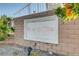 Close-up of the Spanish Villas sign, set in a brick wall with colorful flowers at 4998 Schumann Dr, Las Vegas, NV 89146
