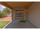 View of covered patio, artificial turf, with access to kitchen through sliding glass door at 5001 Volcanic Rock Ln, Las Vegas, NV 89122