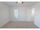 Bright bedroom featuring neutral carpet and access to other rooms at 5001 Volcanic Rock Ln, Las Vegas, NV 89122