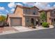 Two-story home featuring a tile roof, stucco exterior, and attached one-car garage at 5001 Volcanic Rock Ln, Las Vegas, NV 89122