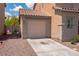 Side of house with a one car garage, long driveway and easy to maintain desert rock at 5001 Volcanic Rock Ln, Las Vegas, NV 89122