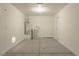 Spacious garage with concrete floors, water heater, and door leading to the house at 5001 Volcanic Rock Ln, Las Vegas, NV 89122