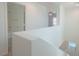 Upstairs hallway with views to the laundry area and bathroom with shower at 5001 Volcanic Rock Ln, Las Vegas, NV 89122