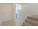 Hallway view showcasing laundry area entrance and stairway at 5001 Volcanic Rock Ln, Las Vegas, NV 89122