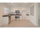 Bright kitchen featuring white cabinets, stainless steel appliances, and tile flooring at 5001 Volcanic Rock Ln, Las Vegas, NV 89122