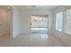 Tiled living room showcasing sliding glass doors to the backyard patio at 5001 Volcanic Rock Ln, Las Vegas, NV 89122