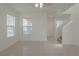 Well-lit living room with tile floors, and a staircase to the upper level at 5001 Volcanic Rock Ln, Las Vegas, NV 89122