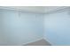 Spacious walk-in closet features carpeted floors and shelf and rod system for storage at 5001 Volcanic Rock Ln, Las Vegas, NV 89122