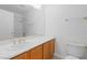 Clean bathroom featuring a white countertop vanity, sink, and matching toilet at 5396 Valley Wells Way, Las Vegas, NV 89113
