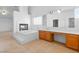 Bright bathroom features a soaking tub with fireplace and a vanity with a large mirror at 5396 Valley Wells Way, Las Vegas, NV 89113