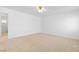This bedroom features a neutral carpet, ceiling fan, and closet at 5396 Valley Wells Way, Las Vegas, NV 89113