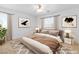 This bedroom features a ceiling fan, two windows, and modern decor at 5396 Valley Wells Way, Las Vegas, NV 89113