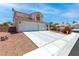 Charming two-story home with a three car garage and well-maintained landscaping at 5396 Valley Wells Way, Las Vegas, NV 89113