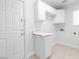 Efficient laundry room with white cabinets, countertop, and door to the exterior at 5396 Valley Wells Way, Las Vegas, NV 89113