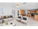 Open-concept living room and kitchen with stainless steel appliances and breakfast bar at 5396 Valley Wells Way, Las Vegas, NV 89113