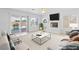Comfortable living room with fireplace, a view of the pool, and a sliding glass door at 5396 Valley Wells Way, Las Vegas, NV 89113