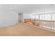 This loft features neutral carpet and a decorative wood railing at 5396 Valley Wells Way, Las Vegas, NV 89113