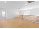 Spacious upstairs loft area with carpet flooring, a window, and a view of the downstairs at 5396 Valley Wells Way, Las Vegas, NV 89113