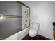 Outdated bathroom features a shower-tub combo with gold trim, wood vanity and dark floors at 540 Tam O Shanter, Las Vegas, NV 89109
