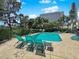 Community pool and sun deck with lounge chairs surrounded by lush landscaping and trees at 540 Tam O Shanter, Las Vegas, NV 89109