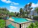 Community pool and sun deck with lounge chairs surrounded by lush landscaping and trees at 540 Tam O Shanter, Las Vegas, NV 89109