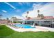 Large backyard with a pool, jacuzzi, covered patio, and manicured lawn at 5515 Coley Ave, Las Vegas, NV 89146