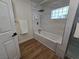 Well-lit bathroom featuring a bathtub with shower head and glass divider at 5515 Coley Ave, Las Vegas, NV 89146