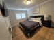 Comfortable bedroom with modern decor, hardwood floors, and television on the wall at 5515 Coley Ave, Las Vegas, NV 89146