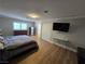 Primary bedroom features hardwood floors, a closet and large windows for natural light at 5515 Coley Ave, Las Vegas, NV 89146