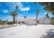 Expansive front yard and driveway leading to a charming single-story home with a detached garage at 5515 Coley Ave, Las Vegas, NV 89146