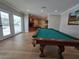 Game room with a pool table and an open view to a fireplace and table in the background at 5515 Coley Ave, Las Vegas, NV 89146