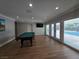 Bright game room featuring a pool table and a view of the pool through large sliding doors at 5515 Coley Ave, Las Vegas, NV 89146