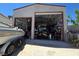Angle view of a large detached garage with open doors and filled with storage at 5515 Coley Ave, Las Vegas, NV 89146