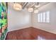 Minimalist bedroom with hardwood floors, a large cartoon mural, and bright light at 5626 Deer Creek Falls Ct, Las Vegas, NV 89118