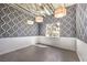 Bright bedroom with hardwood floors, damask wallpaper, and exposed ceiling at 5626 Deer Creek Falls Ct, Las Vegas, NV 89118