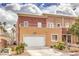 Inviting two-story home featuring a garage, well-kept lawn, and lush landscaping at 5626 Deer Creek Falls Ct, Las Vegas, NV 89118