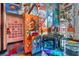 Funky game room features colorful murals, foosball table, and quirky decor, perfect for entertaining guests at 5626 Deer Creek Falls Ct, Las Vegas, NV 89118