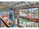 Unique interior view with high ceilings, colorful cartoon murals and large windows providing natural light and outdoor views at 5626 Deer Creek Falls Ct, Las Vegas, NV 89118