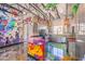 Kitchen with epoxy floors, graffiti decor, and stainless appliances at 5626 Deer Creek Falls Ct, Las Vegas, NV 89118