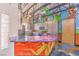 Bright kitchen features graffiti on walls and unique island design at 5626 Deer Creek Falls Ct, Las Vegas, NV 89118