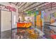 Open kitchen with colorful graffiti and epoxy flooring at 5626 Deer Creek Falls Ct, Las Vegas, NV 89118