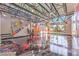 Open living area with vibrant graffiti art, a staircase, and ample natural light at 5626 Deer Creek Falls Ct, Las Vegas, NV 89118
