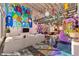 Open-concept living area with vibrant murals, stylish seating, and unique loft design, perfect for modern living at 5626 Deer Creek Falls Ct, Las Vegas, NV 89118