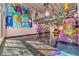 Large living space with graffiti art, high ceilings, and a second-story loft at 5626 Deer Creek Falls Ct, Las Vegas, NV 89118